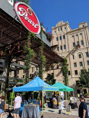 Market tents set up under Pearl's iconic sign