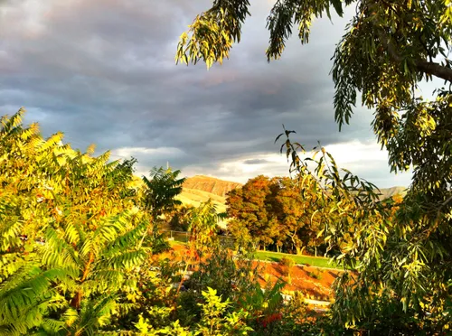 Lush vegetation frames a dramatic sky in the park's southeast corner