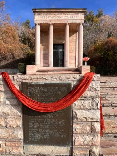 The Meditation Chapel with a commemorative red ribbon draped across the entrance marker