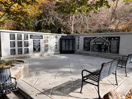 The Korean War Wall of Honor with iron benches on the memorial plaza
