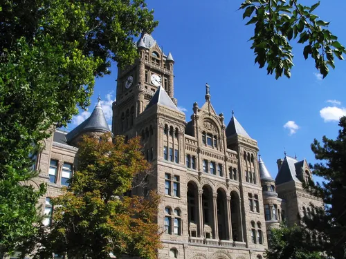 Afternoon light illuminates the clock tower and intricate stonework