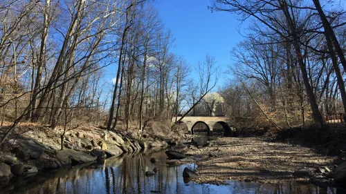 Holmes Run flows quietly beneath the stone arch bridge on North Beauregard Street