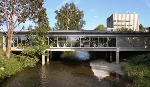 The Renton Library sits above the Cedar River on a glass-walled bridge structure