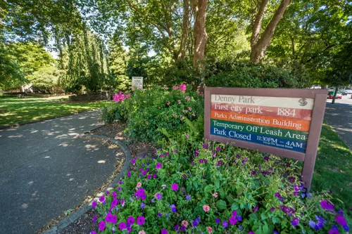 Park information sign nestled among blooming plants