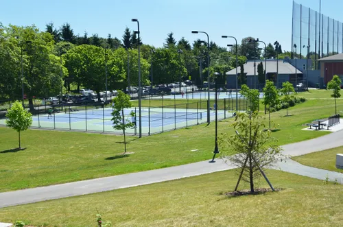 Well-maintained tennis courts surrounded by green lawns