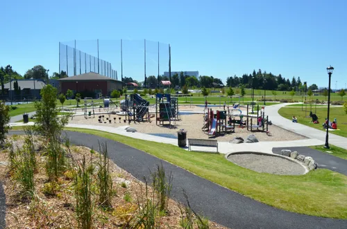 Playground equipment and gathering areas connected by paved pathways