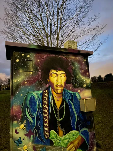 Vibrant mural on a utility box by the sidewalk