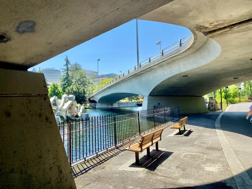 Modern curved underpass with riverside seating