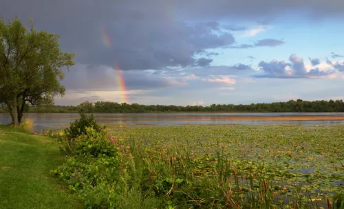 A rainbow arches over Lake Wingra looking south