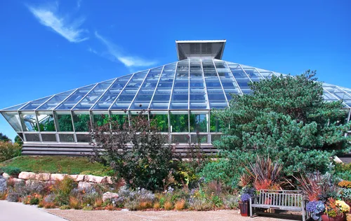 The botanical garden's glass conservatory showcases plant collections