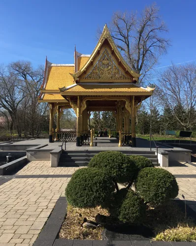 The golden Thai Pavilion surrounded by manicured shrubbery