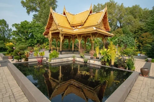 The Thai Pavilion's golden roof gleams above tranquil water