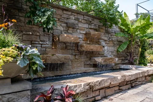 Stone wall with small cascading waterfalls