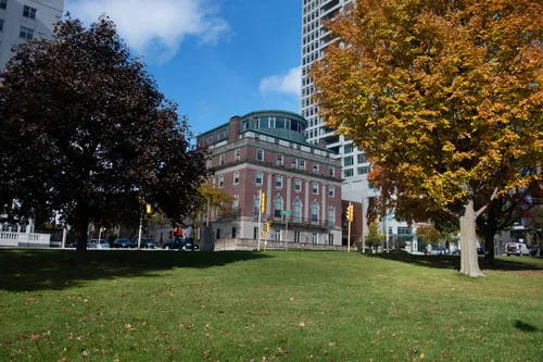 Fall foliage frames a view of the buildings along the park's western edge
