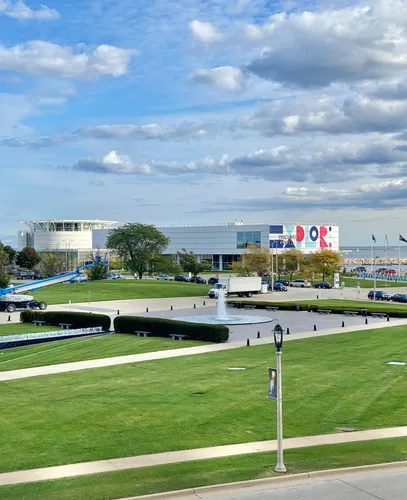 Expansive green lawns with fountain and the Discovery World museum in the background