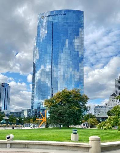 A glass tower provides a spectacular backdrop to the park landscape