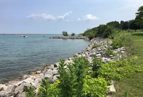Rocky shoreline meets the waters of Lake Michigan on a clear day
