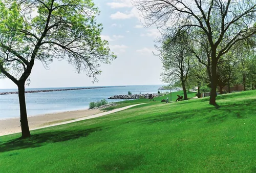 Green lawns slope gently toward the shoreline